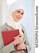 Muslim Caucasian female student with notebook and pen