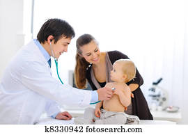 Surprised baby being checked by a doctor using a stethoscope