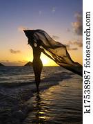 woman on the beach at sunrise woman on the beach at sunrise