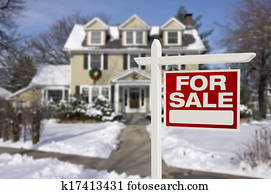Home For Sale Sign in Front of Snowy New House