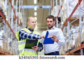 worker and businessmen with clipboard at warehouse worker and businessmen with clipboard at warehouse