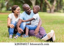 young african family sitting outdoors