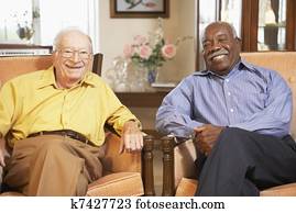 Senior men relaxing in armchairs