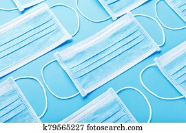 Medical hygienic mask, Face protective masks on blue background. Disposable surgical face mask protective against Coronovirus Covid-19,pollution, virus, flu. Healthcare medical surgical Flat lay pattern Medical hygienic mask, Face protective masks on blue background. Disposable surgical face mask protective against Coronovirus Covid-19,pollution, virus, flu. Healthcare medical surgical Flat lay pattern