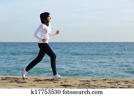 Arab saudi runner woman running on the beach
