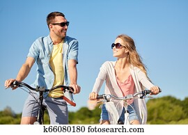 happy young couple riding bicycles in summer happy young couple riding bicycles in summer