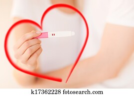 woman and man hands with pregnancy test woman and man hands with pregnancy test