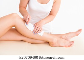 Female Therapist Waxing Customer's Leg Female Therapist Waxing Customer's Leg