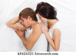 young upset couple in bed
