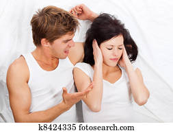 young upset couple in bed