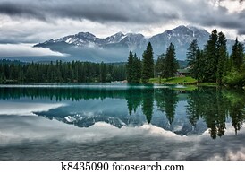 Foggy morning over Canadian Rocky Mountains perfectly mirrors