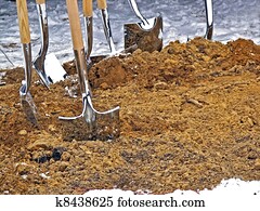 shiny shovels in dirt