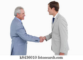 Side view of tradesmen shaking hands