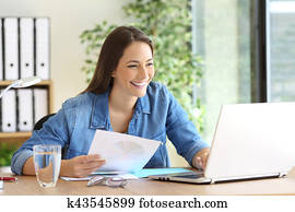 Entrepreneur working comparing documents online Entrepreneur working comparing documents online
