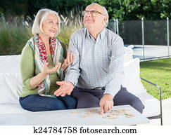 Happy Senior Couple Playing Dominoes At Nursing Home Porch Happy Senior Couple Playing Dominoes At Nursing Home Porch