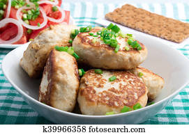 Homemade chicken burgers and salad with fresh tomatoes