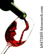 Red wine pouring into wine glass Red wine pouring into wine glass