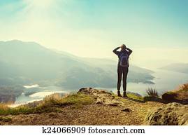 Female hiker on top of the mountain enjoying valley view, Ben A'an, Loch Katrina, Highlands, Scotland, UK
