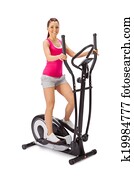 Young woman uses elliptical cross trainer.