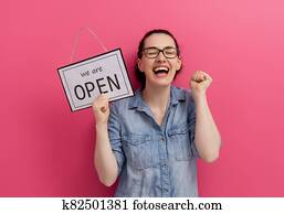 business owner holding the sign for the reopening business owner holding the sign for the reopening