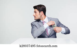 Businessman putting money in pocket Businessman putting money in pocket