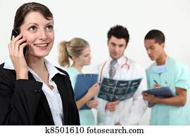 businesswoman in a hospital talking on her cell