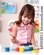 Child preschooler painting in classroom. Child preschooler painting in classroom.