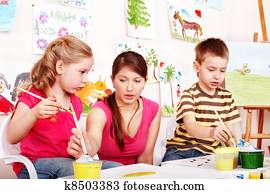 Children with teacher draw paints in play room. Children with teacher draw paints in play room.