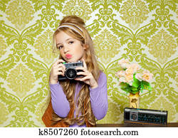 hip retro little girl shooting photo on vintage camera