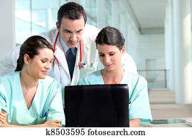 Resident doctor talking with interns