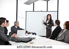 Business meeting - group of people in office at presentation