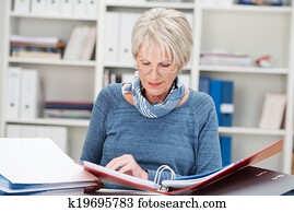 Elderly businesswoman hard at work at the office