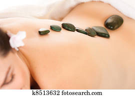 Fit woman getting a hot stone massage Fit woman getting a hot stone massage