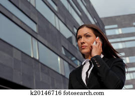 Beautiful business woman on the phone at modern building Beautiful business woman on the phone at modern building