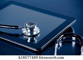 medical stethoscope on modern digital tablet pc in laboratory on wood table