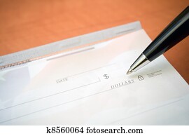 Financial concept check and pen