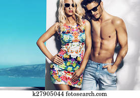 Happy fashionable couple on sunny vacation day