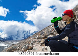 Woman drinking in mountains Woman drinking in mountains