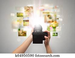 Hand captures life events with digital camera