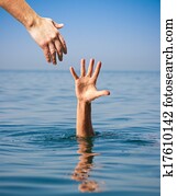 helping hand giving to drowning man in sea