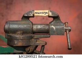 Vice grip tool squeezing a plank with the word menage Vice grip tool squeezing a plank with the word menage