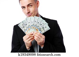 Rich businessman holding US dollars isolated on a white background