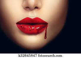Sexy vampire woman lips with dripping blood Sexy vampire woman lips with dripping blood