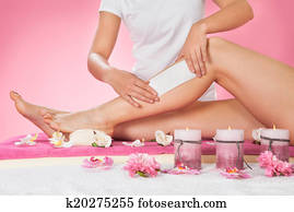 Therapist Waxing Customer's Leg At Spa Therapist Waxing Customer's Leg At Spa