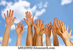 Hands raised up in air across blue sky Hands raised up in air across blue sky