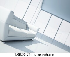 modern white leather sofa in a light interior with large windows