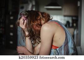 Sad woman at home with a head ache