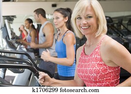 Woman Running On Treadmill At Gym Woman Running On Treadmill At Gym
