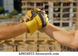 Handshake over building site