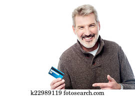Smiling aged man showing his debit card